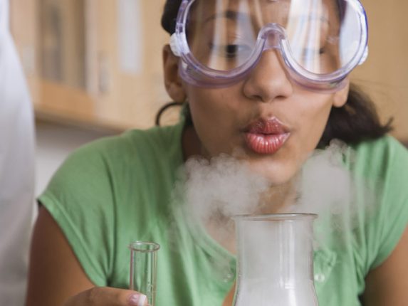 Teenage girl performing a science experiment